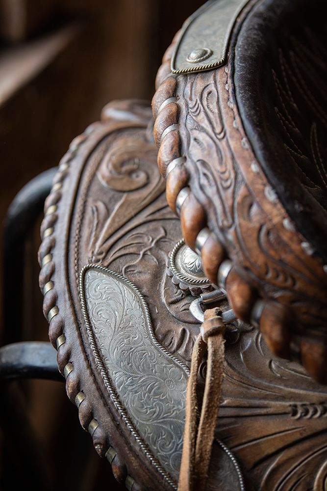 USA-Colorado-Custer County-Westcliffe-Music Meadows Ranch Tack room Tooled leather western saddle